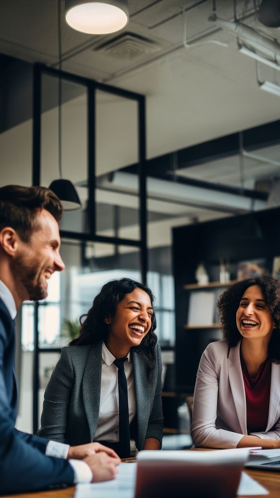 Photo of office workers laughing in the meeting room. 