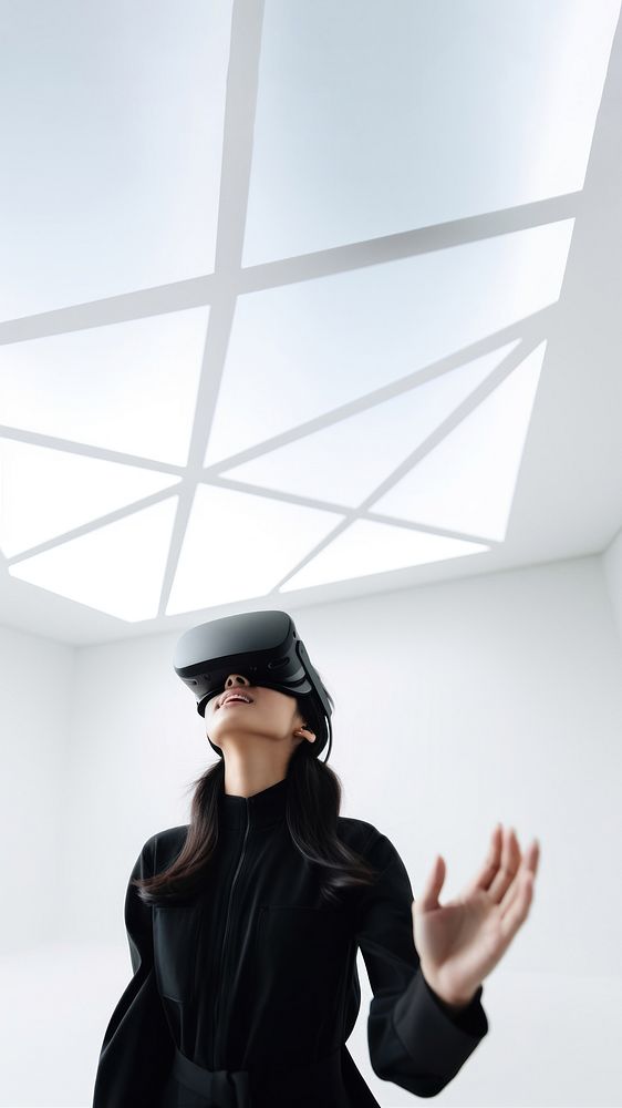 South-East asian girl playing VR game wearing all black outfit. 