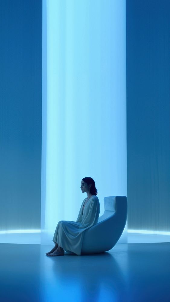 Woman sitting in a white room. 