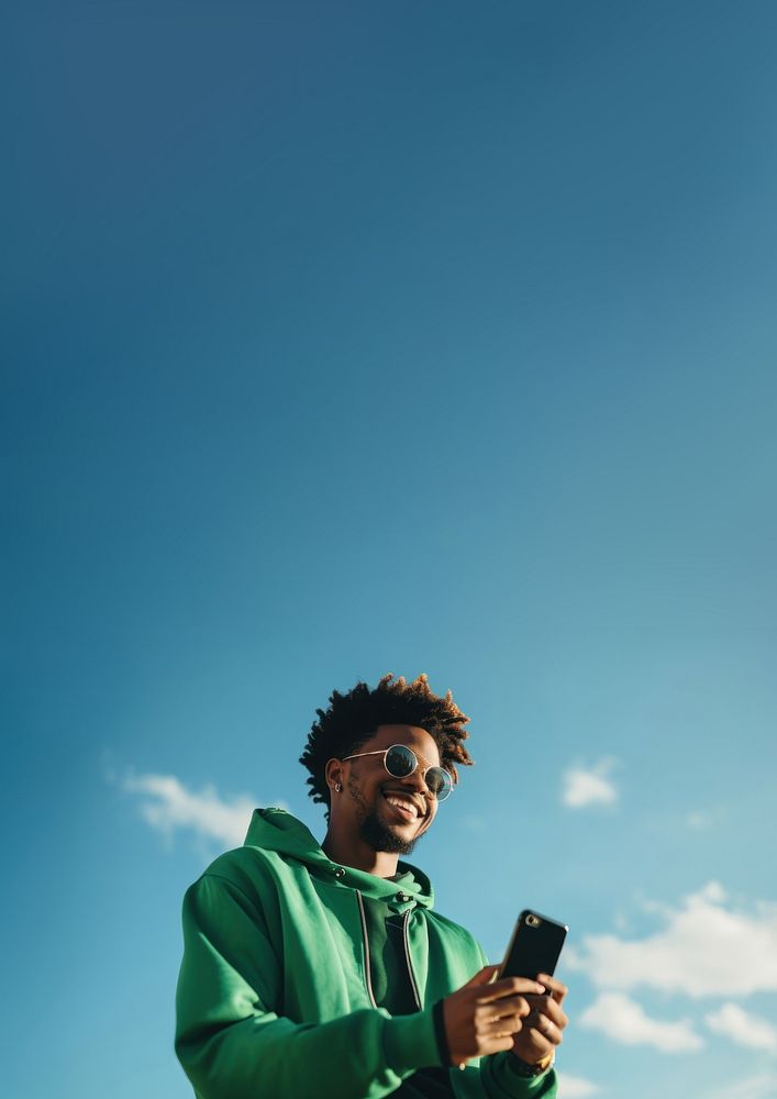 photo of black man wearing green tone outfit using smartphone. AI generated Image by rawpixel.