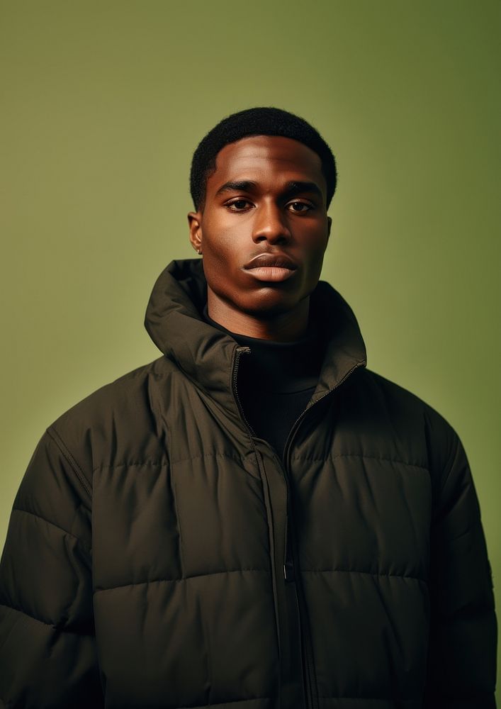 Black man wearing a black puffer jacket portrait adult photo. 