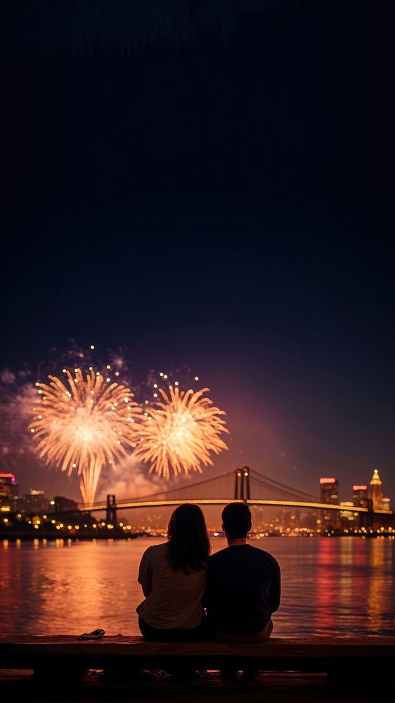 Photo of a couple watching firework on the riverfront, city at night in the background. AI generated Image by rawpixel. 