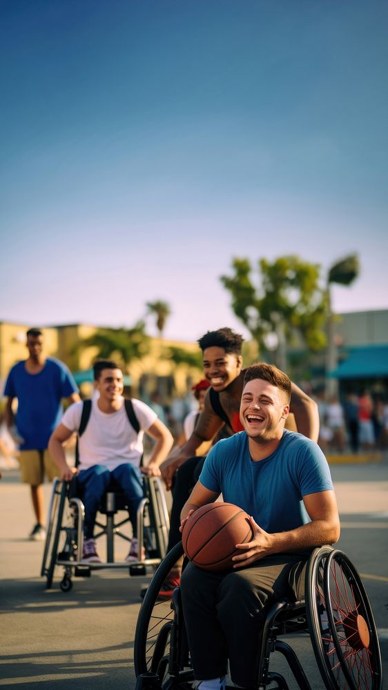 photo of a disable man in wheelchair playing basketball with friends.  