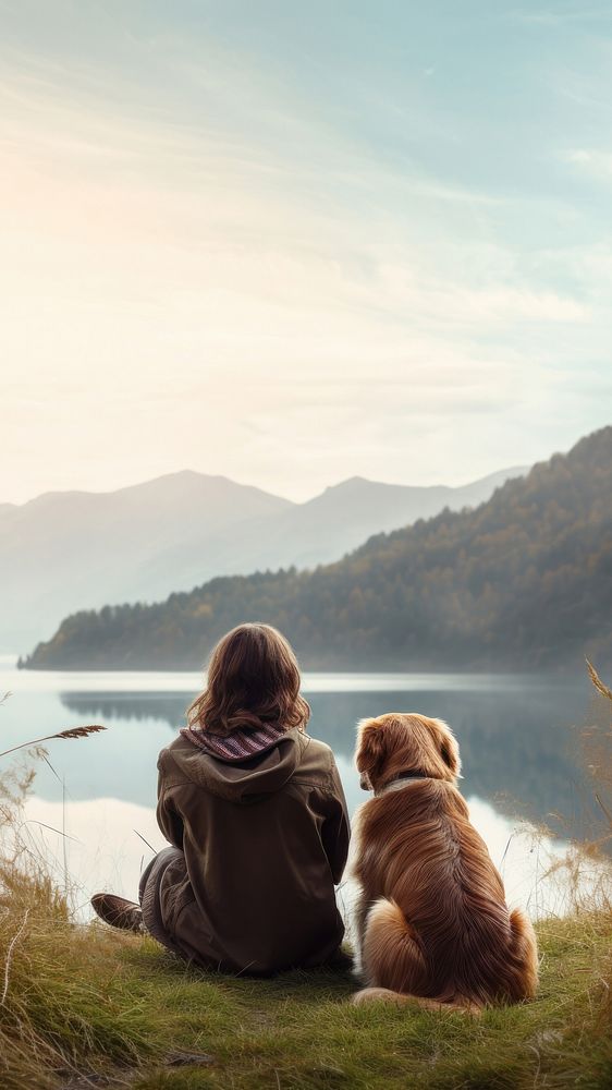 Back view photo of a hiker women sitting in a grass field with her dog looking at the lake. AI generated Image by rawpixel. 