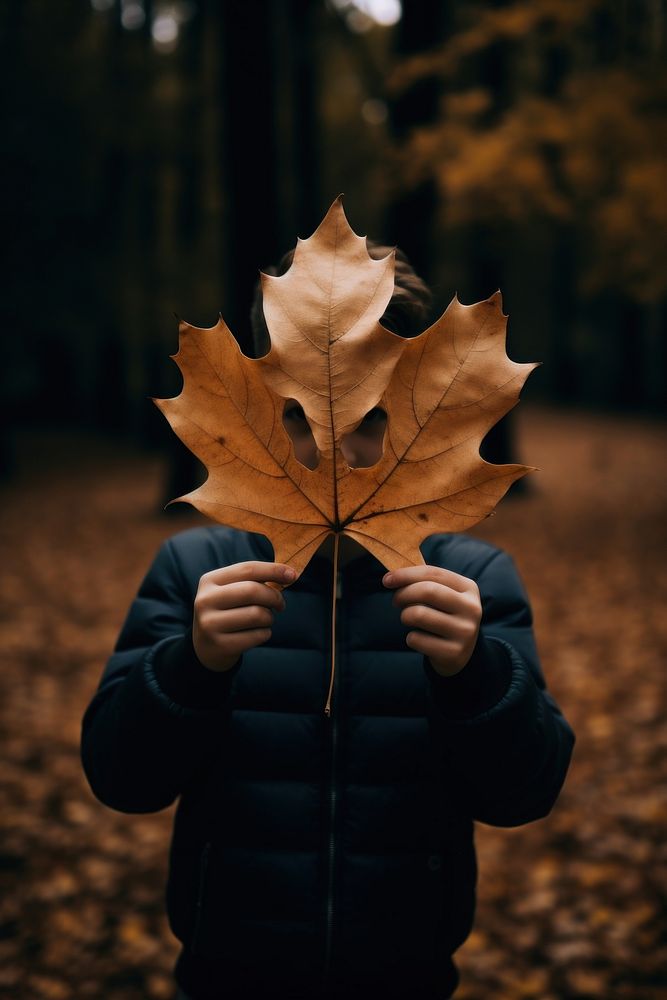 Big autumn leaf portrait holding plant. AI generated Image by rawpixel.