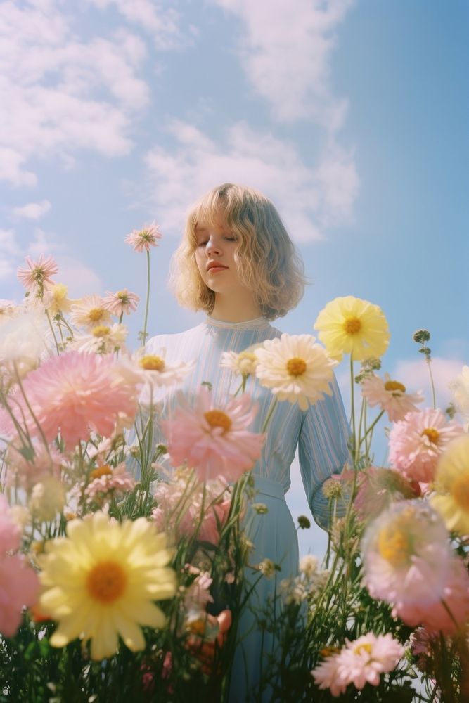 Flower field, woman posing, beautiful sky. 