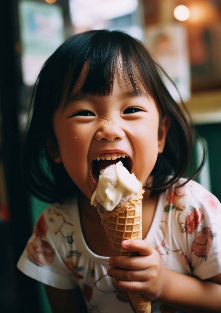 Asian girl smiling dessert eating child. 