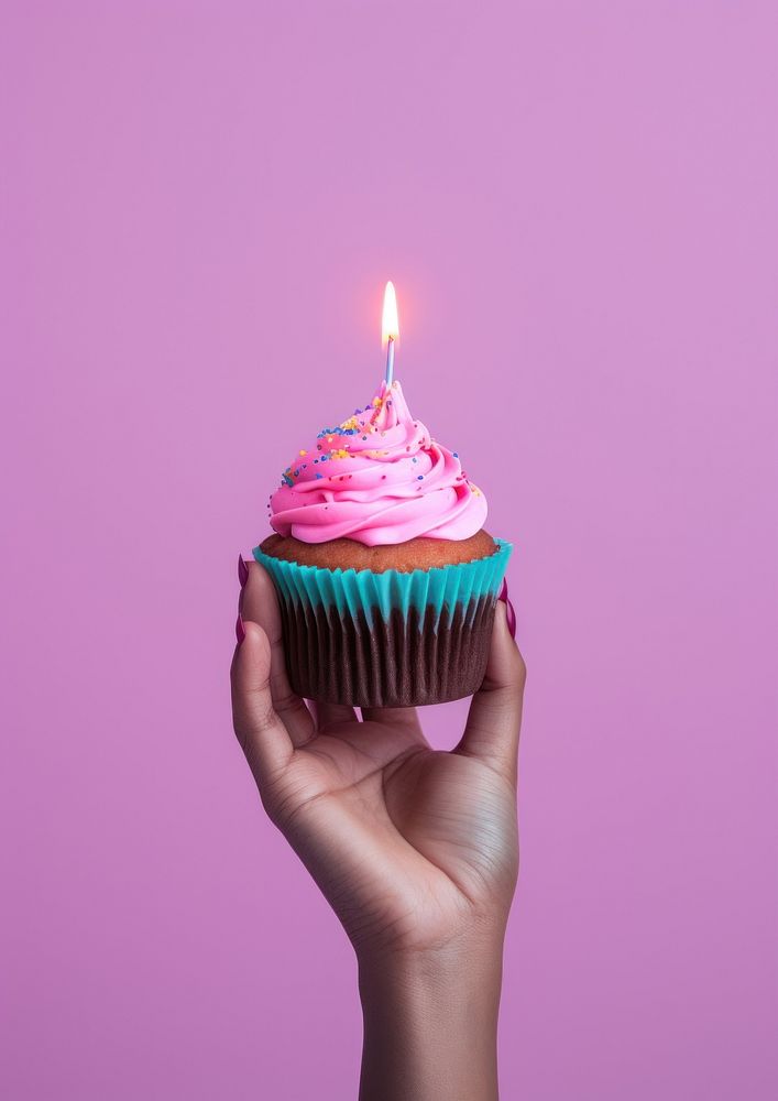 Cupcake candle dessert holding. AI generated Image by rawpixel.