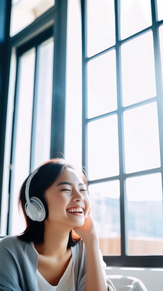 Photo of Asian woman smiling at home in headphones. AI generated Image by rawpixel. 