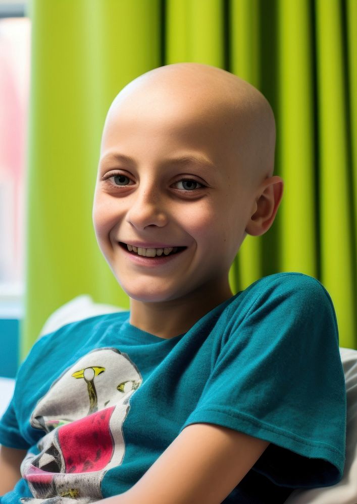photo of a smiling young boy, cancer patient, in a hospital room. AI generated Image by rawpixel.