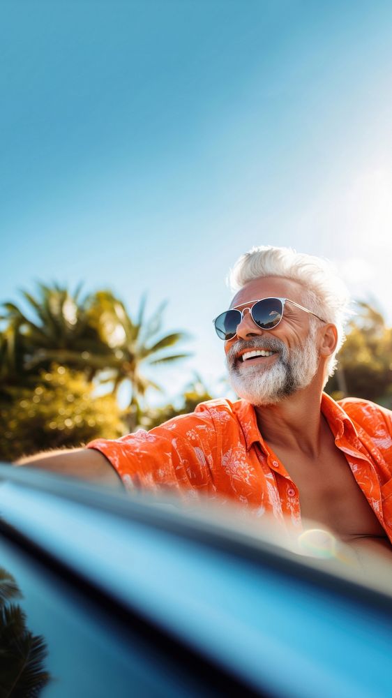 Photo of Happy senior man enjoying summer road trip, luxury cabriolet adventure.