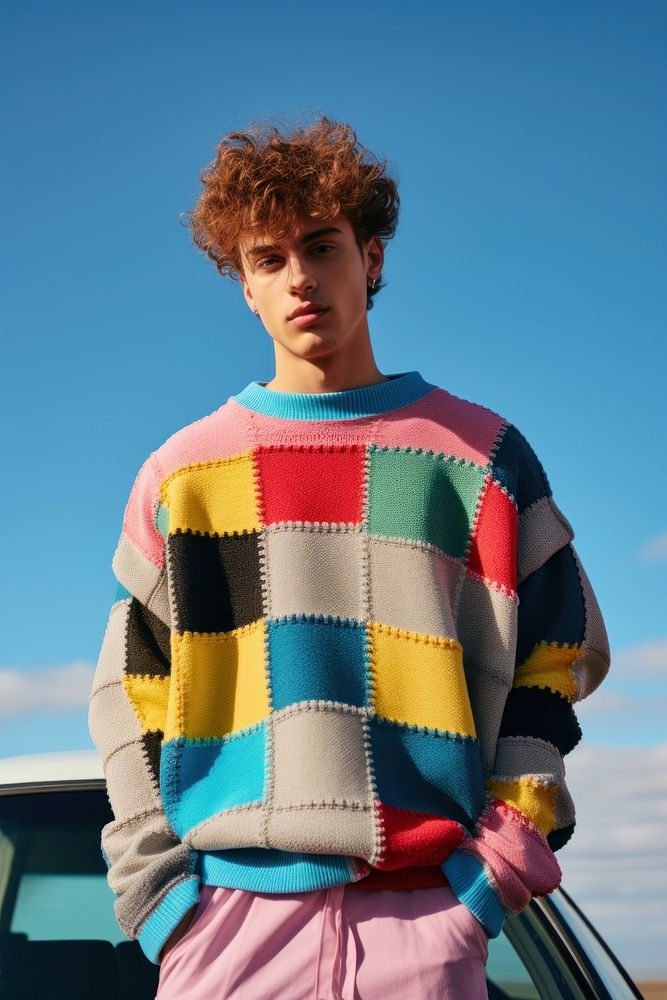 Wearing colorful sweater standing blue sky. 