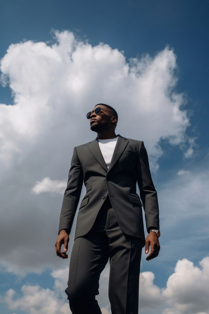 Black man sky standing outdoors. 