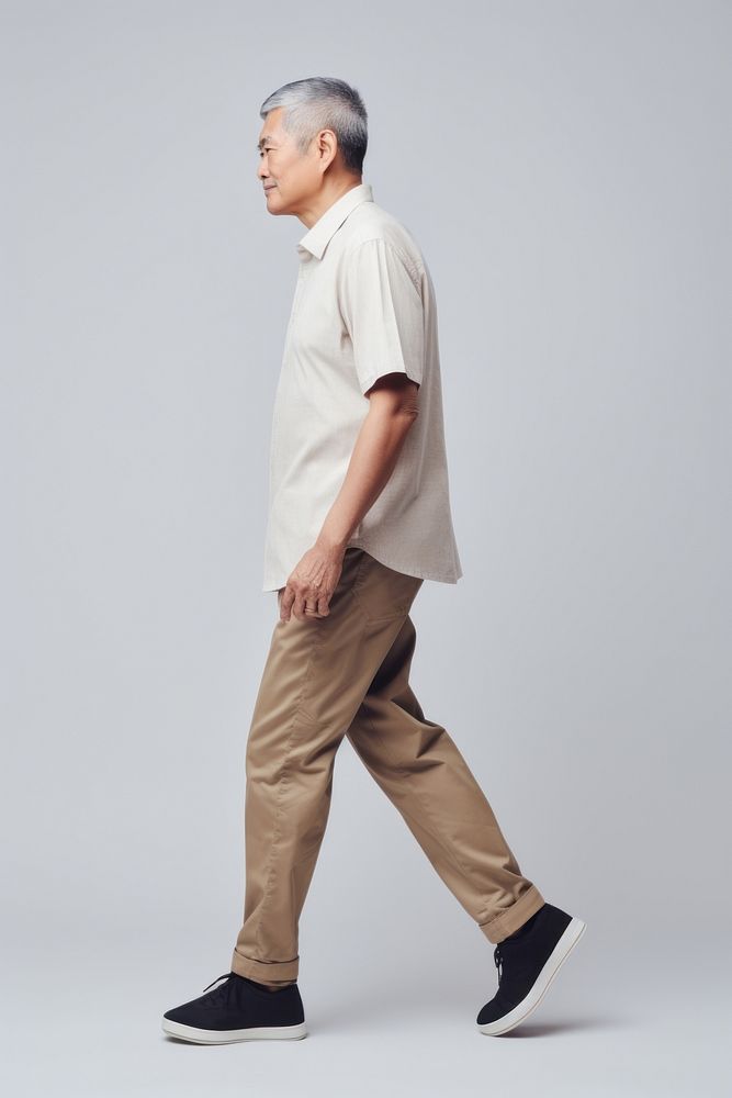 A senior asian man standing walking adult. AI generated Image by rawpixel.
