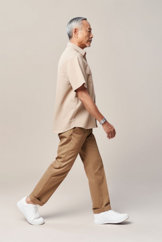 A senior asian man walking adult khaki. AI generated Image by rawpixel.