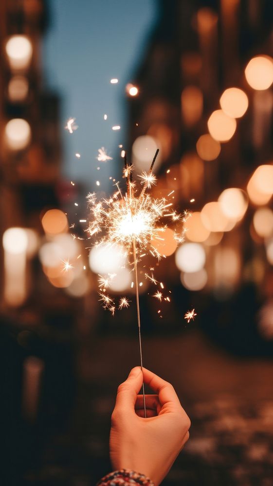 Aesthetic sparkler mobile wallpaper sparks illuminated celebration. AI generated Image by rawpixel.