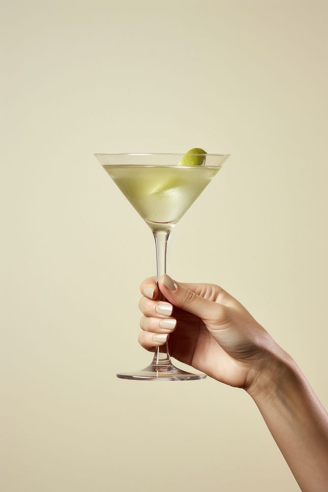 Martini cocktail holding drink glass. AI generated Image by rawpixel.