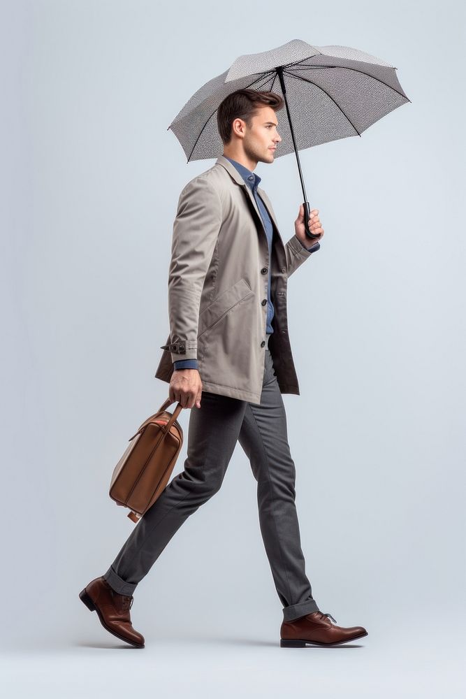 Man holding umbrella walking blazer adult. AI generated Image by rawpixel.