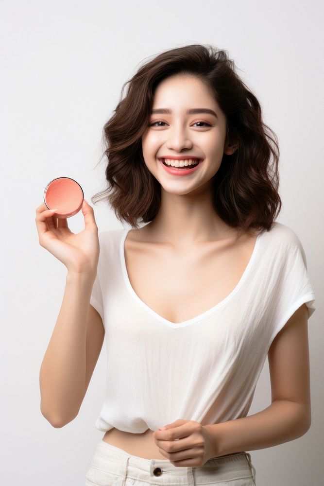 A Young woman holding cosmetic cosmetics portrait smile. AI generated Image by rawpixel.
