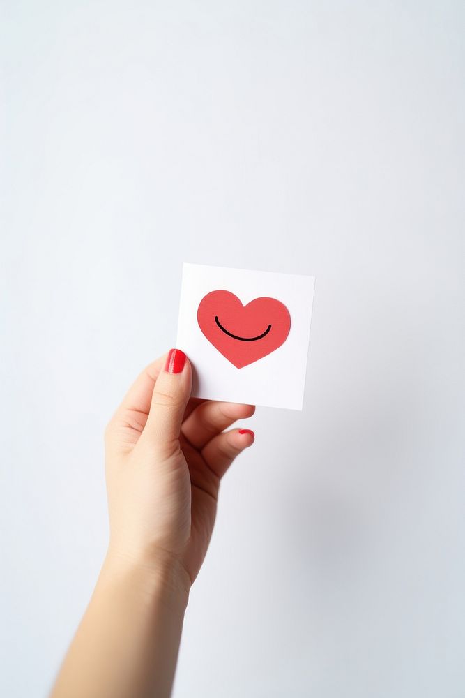 Smile face paper holding heart. AI generated Image by rawpixel.