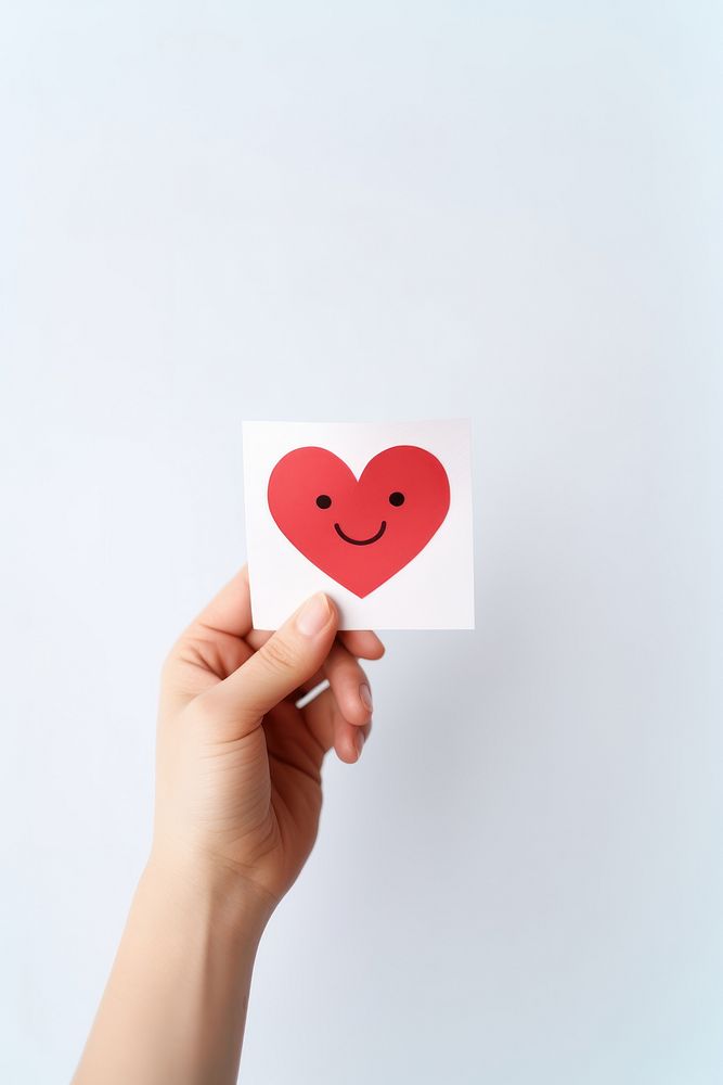 Smile face paper holding heart. AI generated Image by rawpixel.