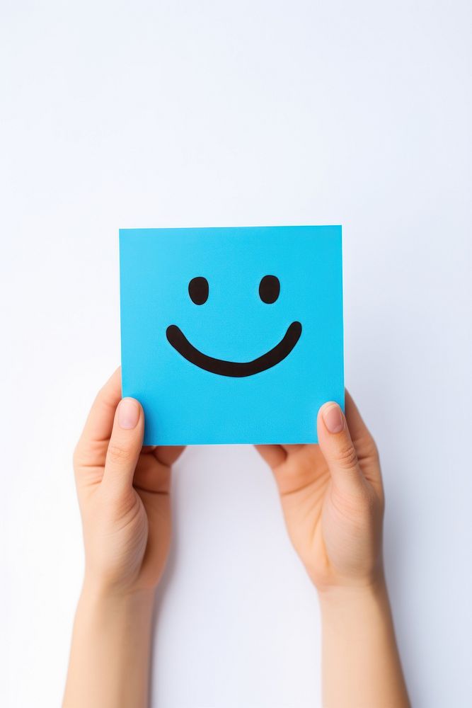 Smile face paper hand blue. AI generated Image by rawpixel.