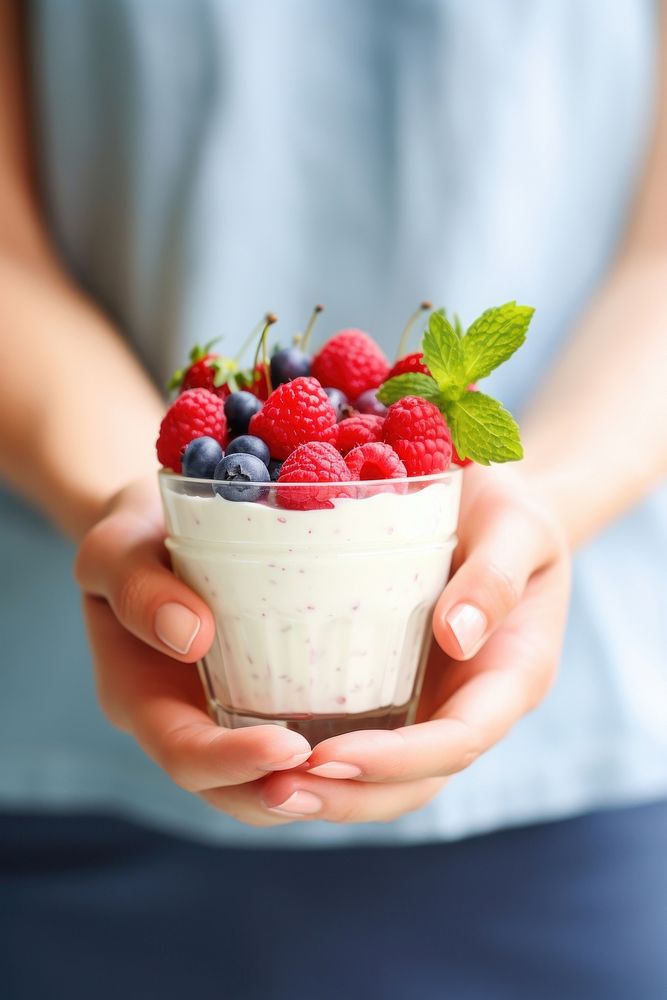 Yogurt dessert berries holding. AI generated Image by rawpixel.