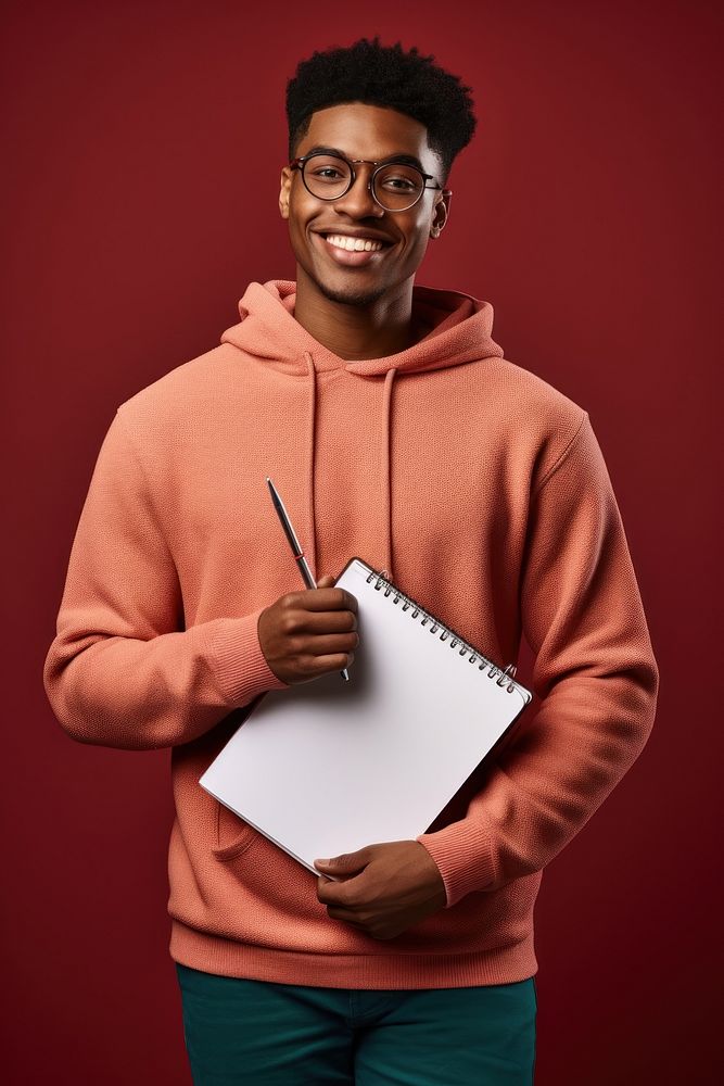 Student holding a notebook and pen sweatshirt portrait glasses. AI generated Image by rawpixel.