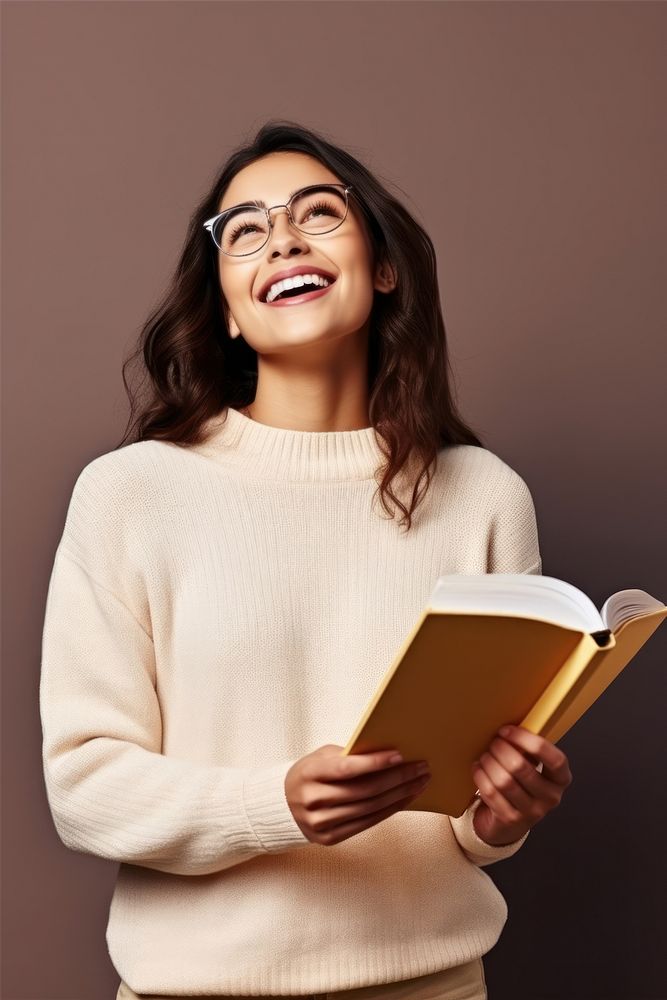 Student holding a book reading looking glasses. AI generated Image by rawpixel.