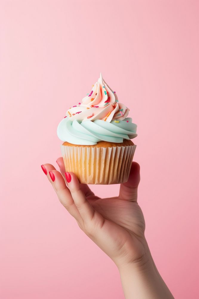 Hand holding birthday cupcake dessert icing cream. AI generated Image by rawpixel.