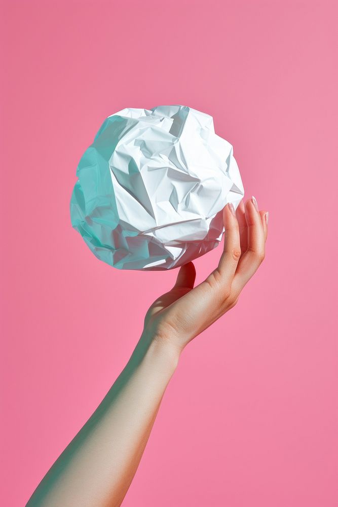 Hand holding small crumple paper ball origami art crumpled. AI generated Image by rawpixel.