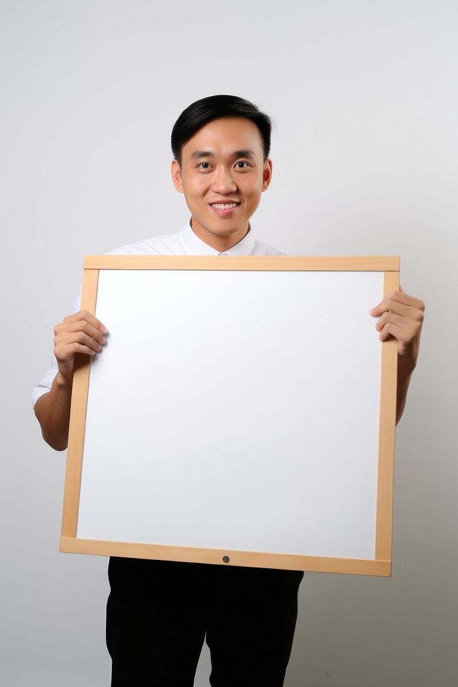 A asian barista man portrait holding photo. AI generated Image by rawpixel.