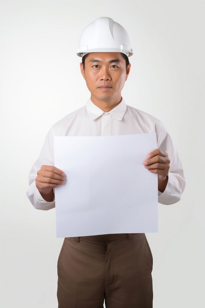 A asian construction worker in uniform man portrait holding hardhat. AI generated Image by rawpixel.