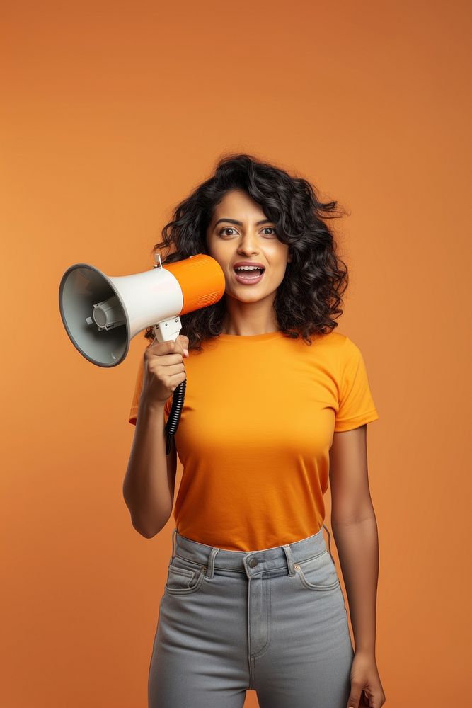 A Young Indian woman holding a megaphone electronics technology sousaphone. AI generated Image by rawpixel.