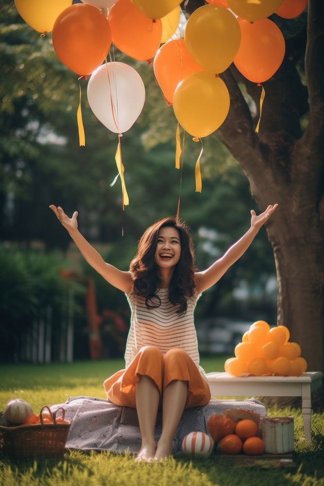 South east asia woman stretch the hand to sky sitting balloon birthday. AI generated Image by rawpixel.