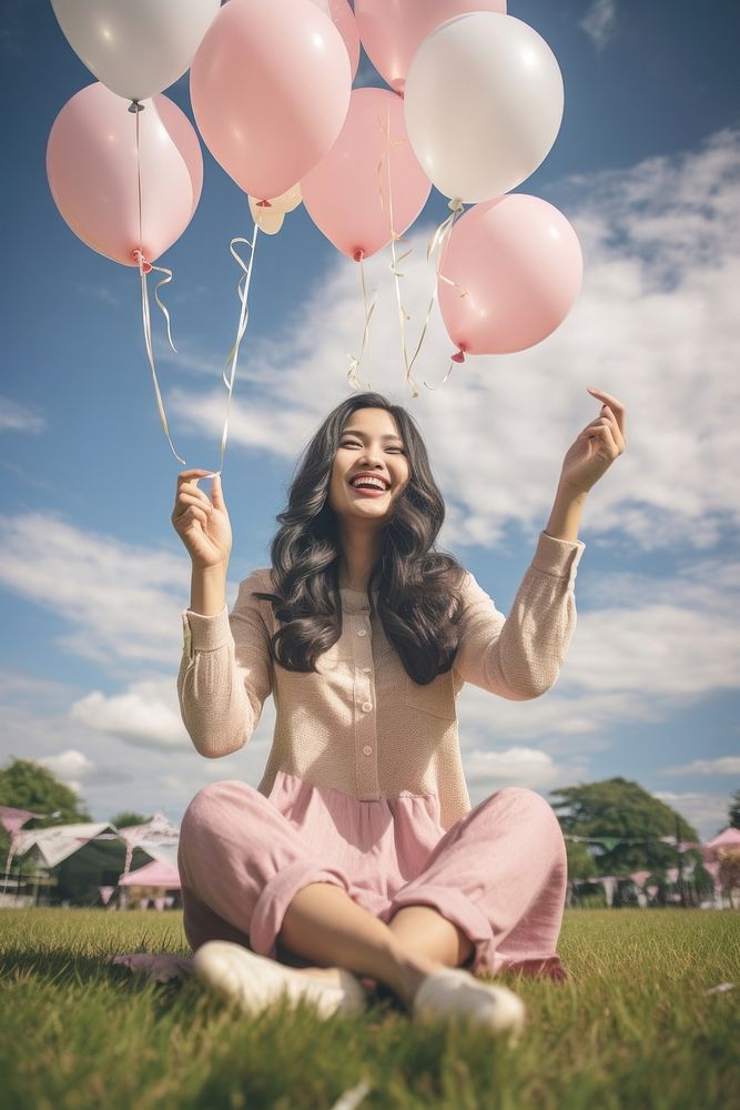 South east asia woman stretch the hand to sky balloon birthday portrait. AI generated Image by rawpixel.