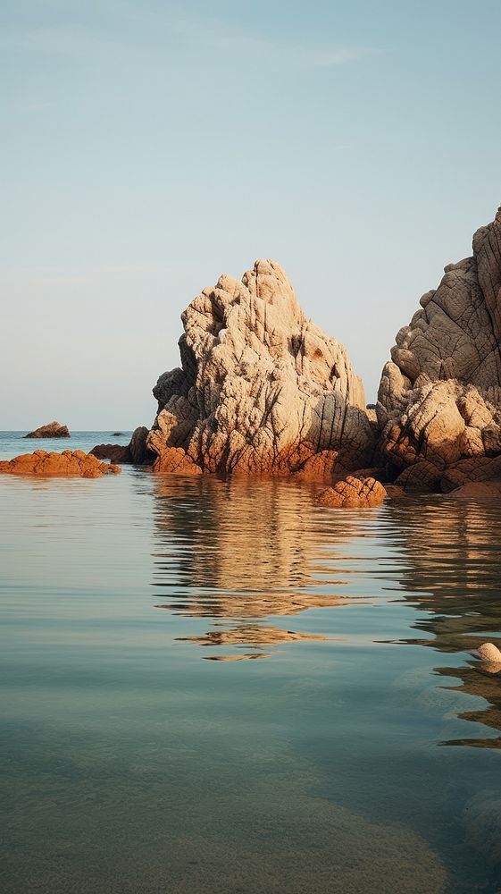 Beautiful beach and water and rock outdoors horizon nature. AI generated Image by rawpixel.
