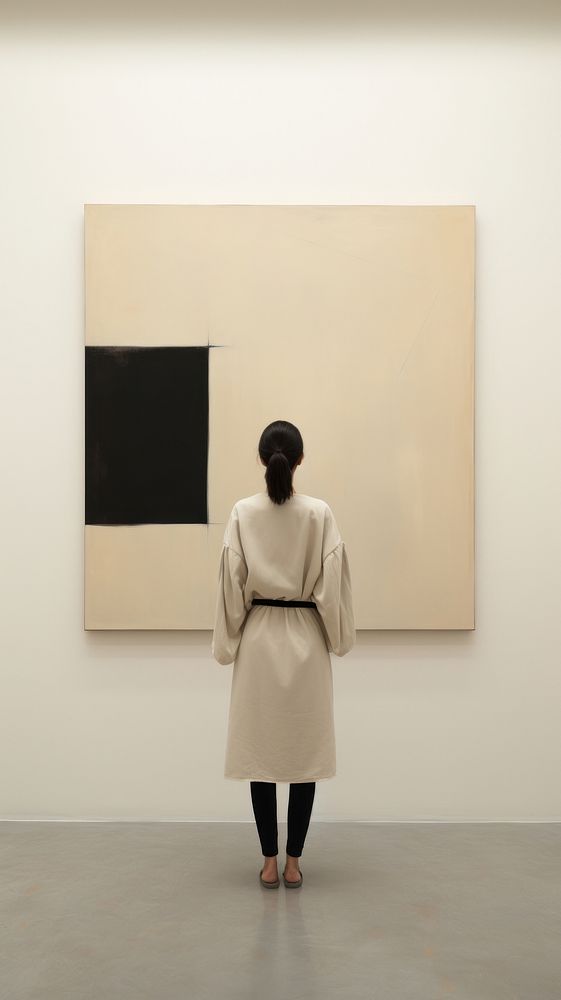 Backview of woman standing in front of abstract painting in museum adult art architecture