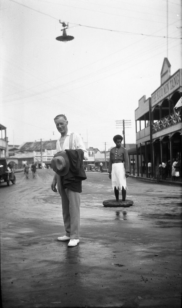 Man standing in Thomson St, Suva, Fiji (1920s to 1930s) by Roland Searle.