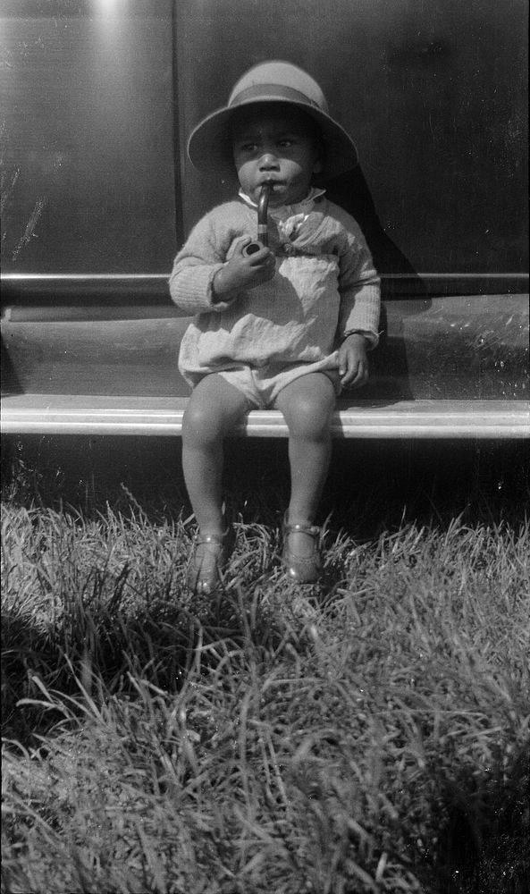 Tihi Kuiti's little boy smoking a pipe (14 November 1937) by Leslie Adkin.