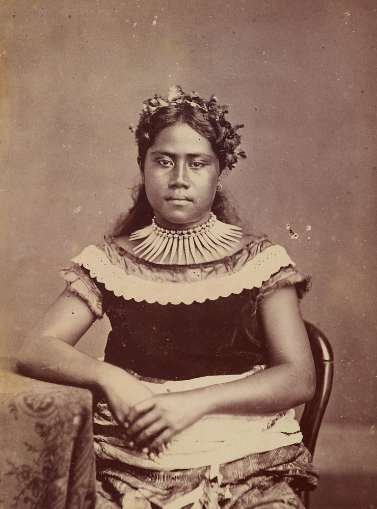 Young woman sitting at table. From the album: Tahiti, Samoa and New Zealand scenes (1885-1900).