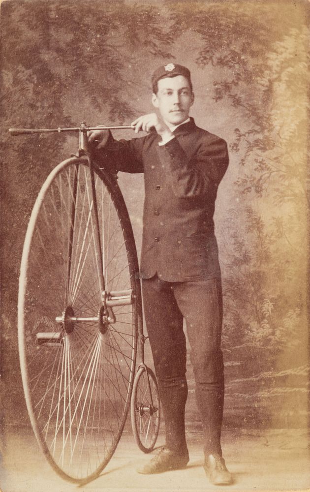 Man with penny-farthing bicycle (1883) by Rutherford and Co.