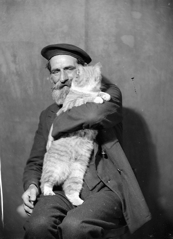 Man holding cat (circa 1935-1939) by Marion Queenie Kirker.