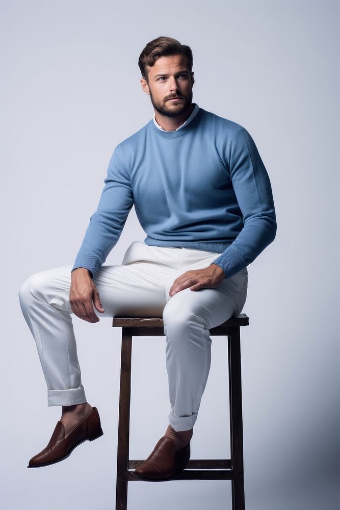 Blue trousers and sweater sitting fashion adult. AI generated Image by rawpixel.