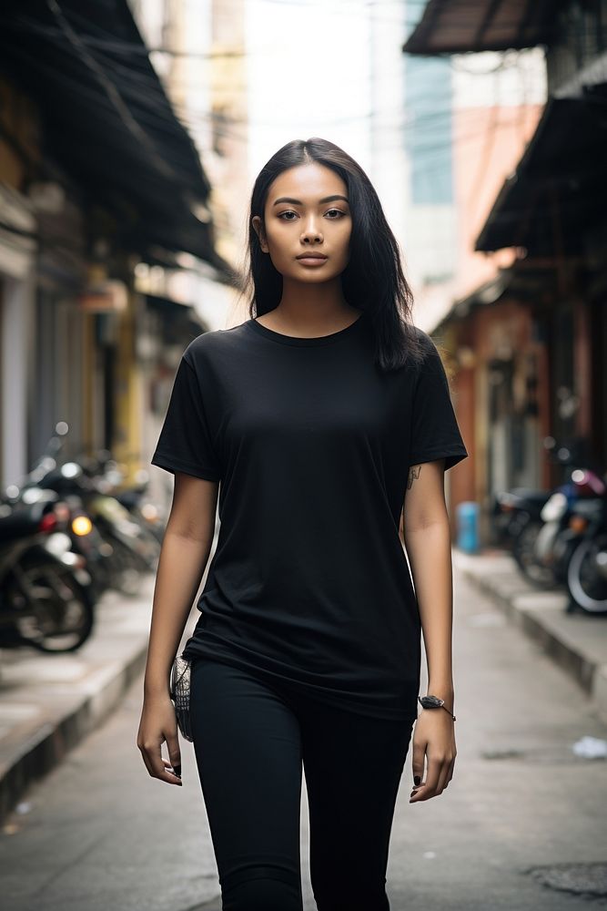 Thai teenager wearing black t-shirt walking street adult transportation. AI generated Image by rawpixel.