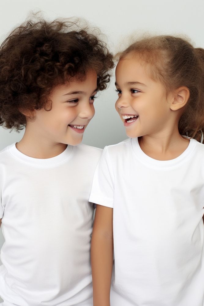Children wearing white t-shirt talking together photography laughing portrait. AI generated Image by rawpixel.