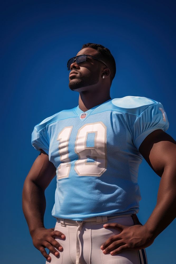 American football player standing t-shirt sports. AI generated Image by rawpixel.