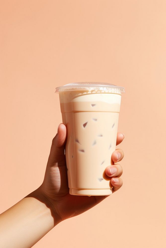 Hand holding milk tea drink cup refreshment. AI generated Image by rawpixel.