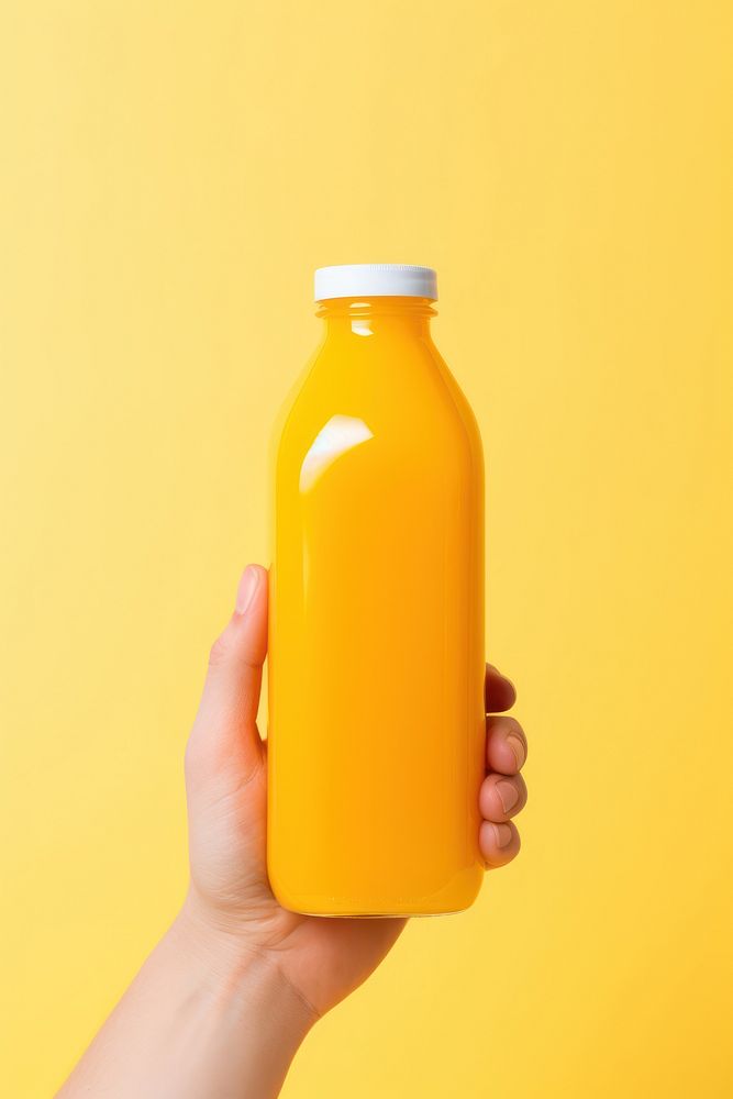 Orange juice holding bottle drink. AI generated Image by rawpixel.
