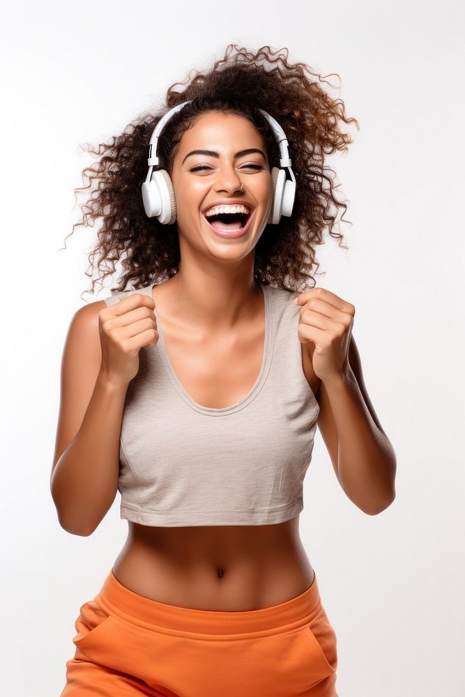 A Beautiful woman wearing gym clothes and headphones dancing happily and cheerful listening shouting laughing. AI generated…